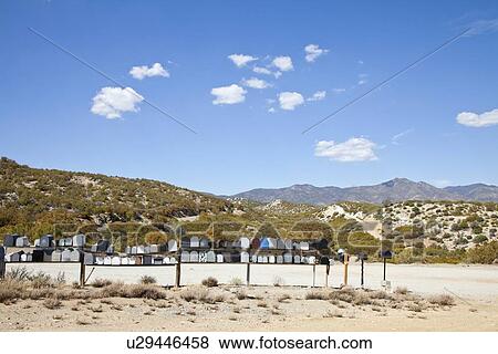 Letter boxes on desert road with mountain background View Large Photo Image Stock Photo - Letter boxes on desert road with mountain background. Fotosearch