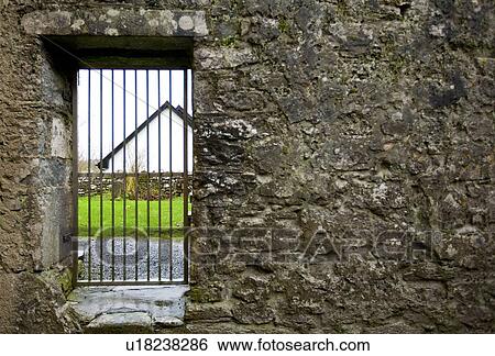 Stock Photograph - Locked gate in old stone wall. Fotosearch
