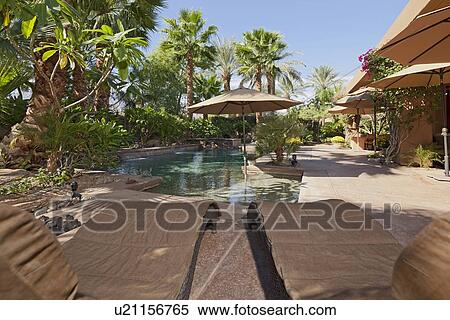 Luxury Villa with water feature and sun beds View Large Photo Image Stock Photography - Luxury Villa with water feature and sun beds. Fotosearch