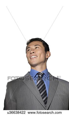 Mid-adult businessman smiling against white background View Large Photo Image Stock Image - Mid-adult businessman smiling against white background. Fotosearch