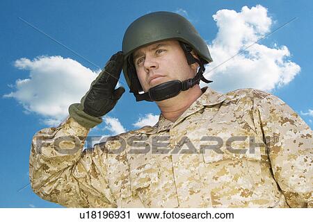 Mid-adult soldier in military uniform saluting against cloudy sky View Large Photo Image Stock Image - Mid-adult soldier in military uniform saluting against cloudy sky. Fotosearch