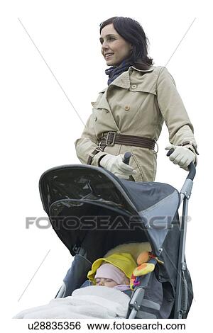 Mother with baby girl in carriage against white background View Large Photo Image Stock Photograph - Mother with baby girl in carriage against white background. Fotosearch