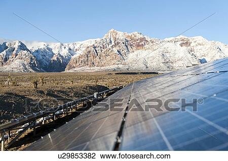 Mountains behind Solar panels View Large Photo Image Stock Image - Mountains behind Solar panels. Fotosearch