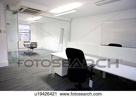 Office desk with meeting room in background View Large Photo Image Stock Image - Office desk with meeting room in background. Fotosearch