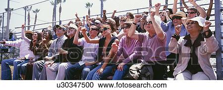 Stock Image - Panoramic shot of crowd cheering in stadium. Fotosearch