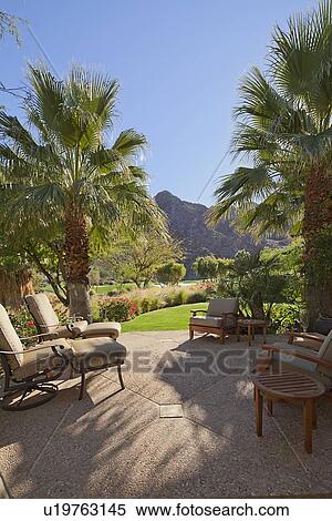 Patio with relaxing chairs and gardens View Large Photo Image Stock Photography - Patio with relaxing chairs and gardens . Fotosearch