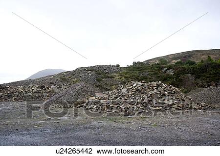 Stock Image - Piles of rocks in small quarry. Fotosearch
