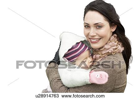 Portrait of beautiful mother holding baby girl against white background View Large Photo Image Stock Image - Portrait of beautiful mother holding baby girl against white background. Fotosearch