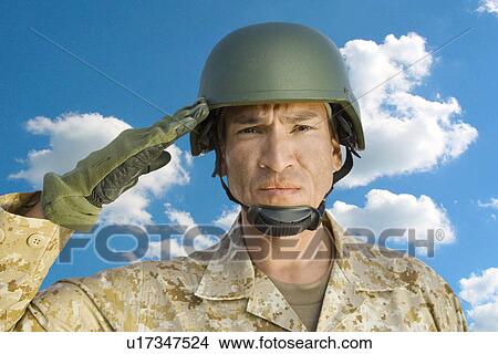 Portrait of middle-aged soldier in military uniform saluting against cloudy sky View Large Photo Image Picture - Portrait of middle-aged soldier in military uniform saluting against cloudy sky. Fotosearch