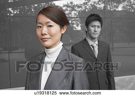 Portrait of young businesswoman with coworker outside office building View Large Photo Image Stock Photography - Portrait of young businesswoman with coworker outside office building. Fotosearch