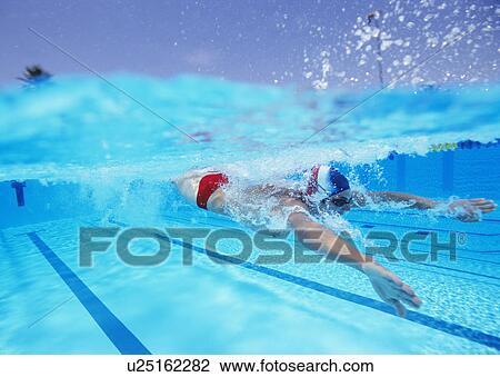 Stock Image - Professional male athlete swimming in pool. Fotosearch