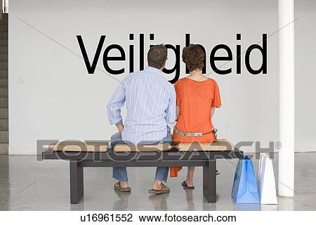 Rear view of couple reading Dutch text "Veiligheid" (security) and contemplating it View Large Photo Image Stock Image - Rear view of couple reading Dutch text "Veiligheid" (security) and contemplating it. Fotosearch