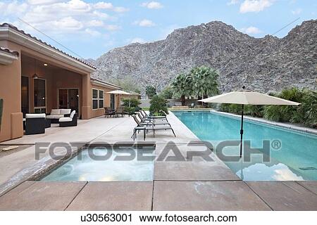 Stock Image - Rear view of luxury villa with swimming pool. Fotosearch