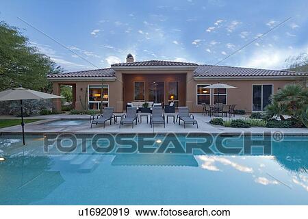 Stock Photo - Rear view of luxury villa with swimming pool. Fotosearch