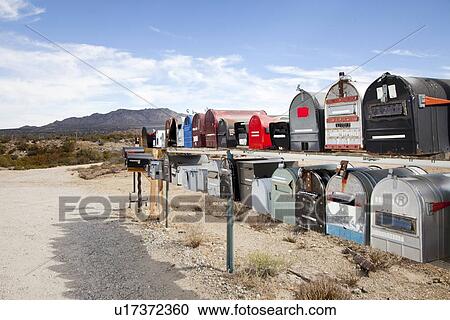 Rows of mailboxes in desert with mountains in background View Large Photo Image Stock Image - Rows of mailboxes in desert with mountains in background. Fotosearch