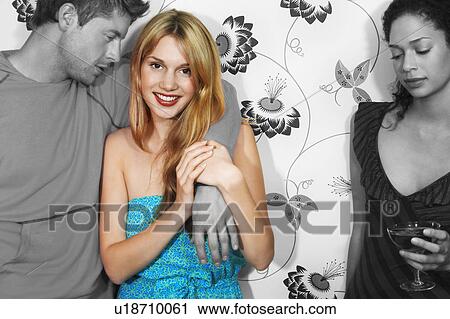 Sad young woman having drink with friends against wall View Large Photo Image Stock Image - Sad young woman having drink with friends against wall. Fotosearch