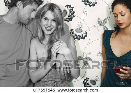 Sad young woman having drink with friends against wall View Large Photo Image Stock Photography - Sad young woman having drink with friends against wall. Fotosearch