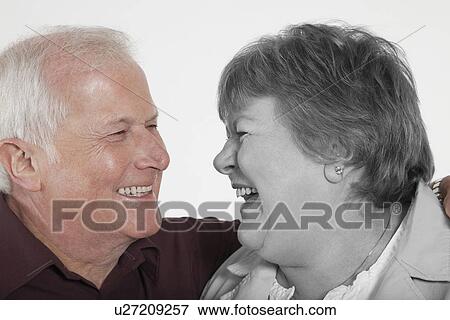 Senior couple looking at each other against white background View Large Photo Image Stock Photo - Senior couple looking at each other against white background. Fotosearch