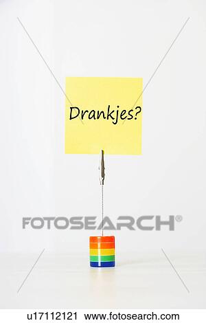 Stock Image - Sticky notepaper with Dutch text meaning "Drankjes? " (Drinks) clipped to a multicolored card holder. Fotosearch