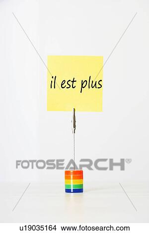 Sticky notepaper with French text "il est plus" (It's over) clipped to a multicolored card holder View Large Photo Image Picture - Sticky notepaper with French text "il est plus" (It's over) clipped to a multicolored card holder. Fotosearch