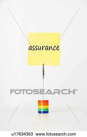 Stock Image - Sticky notepaper with French text "assurance" (Insurance) clipped to a multicolored card holder. Fotosearch