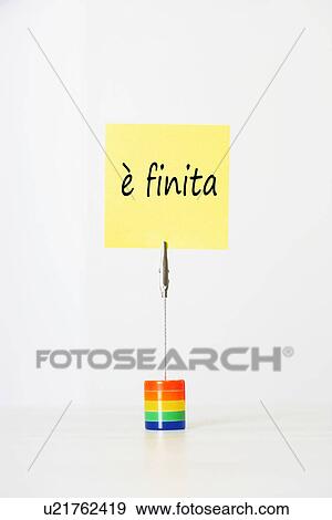 Sticky notepaper with Italian text "è finita" (It's over) clipped to a multicolored card holder View Large Photo Image Stock Photo - Sticky notepaper with Italian text "è finita" (It's over) clipped to a multicolored card holder. Fotosearch