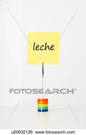 Stock Photograph - Sticky notepaper with Spanish text "leche" (Milk) clipped to a multicolored card holder. Fotosearch