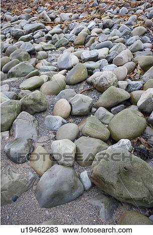 Stock Image - Stones on the beach at Ballinskelling beach, Ireland. Fotosearch