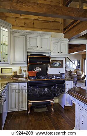 Traditional Kitchen with Cast iron Aga cooker View Large Photo Image Stock Photo - Traditional Kitchen with Cast iron Aga cooker. Fotosearch