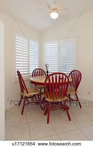Picture - Wooden dining table with red chairs. Fotosearch