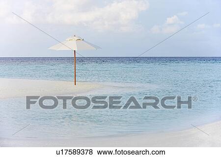 Stock Photo - Beautiful Deserted Beach With Parasol. Fotosearch