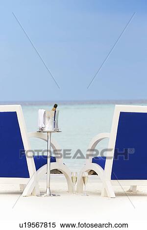 Bottle Of Champagne Between Chairs On Beautiful Beach View Large Photo Image Stock Photography - Bottle Of Champagne Between Chairs On Beautiful Beach. Fotosearch
