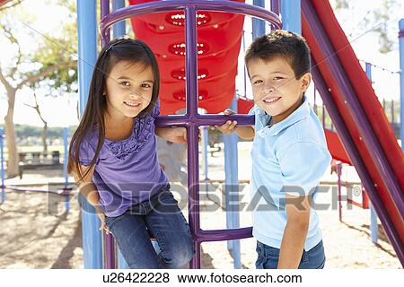 Boy And Girl On Climbing Frame In Park View Large Photo Image Stock Photo - Boy And Girl On Climbing Frame In Park. Fotosearch