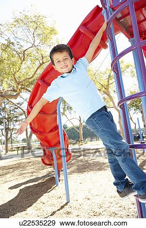 Boy On Climbing Frame In Park View Large Photo Image Stock Photo - Boy On Climbing Frame In Park. Fotosearch