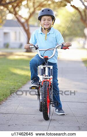 Boy Wearing Safety Helmet Riding Bike View Large Photo Image Stock Photography - Boy Wearing Safety Helmet Riding Bike. Fotosearch