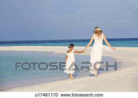 Stock Image - Bride With Bridesmaid At Beautiful Beach Wedding. Fotosearch