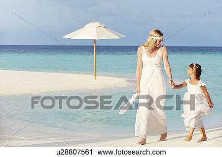 Stock Image - Bride With Bridesmaid At Beautiful Beach Wedding. Fotosearch