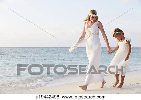 Stock Photo - Bride With Bridesmaid At Beautiful Beach Wedding. Fotosearch