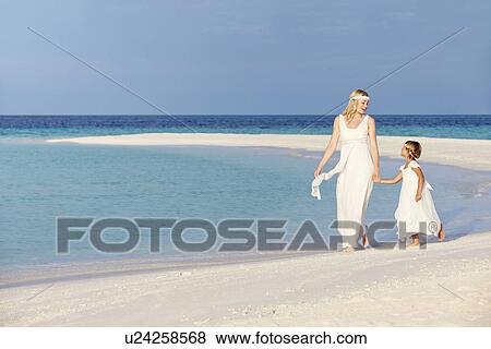 Stock Photo - Bride With Bridesmaid At Beautiful Beach Wedding. Fotosearch