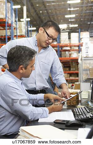 Business Colleagues Working At Desk In Warehouse View Large Photo Image Stock Photo - Business Colleagues Working At Desk In Warehouse. Fotosearch