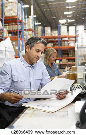 Business Colleagues Working At Desk In Warehouse View Large Photo Image Stock Photo - Business Colleagues Working At Desk In Warehouse. Fotosearch