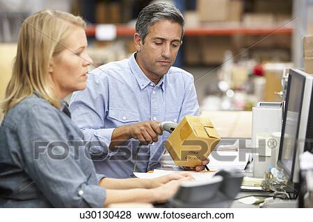 Business Colleagues Working At Desk In Warehouse View Large Photo Image Stock Photo - Business Colleagues Working At Desk In Warehouse. Fotosearch