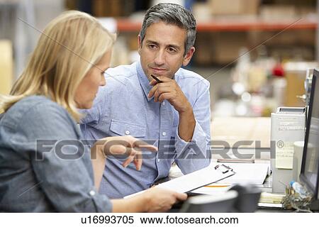 Business Colleagues Working At Desk In Warehouse View Large Photo Image Stock Photography - Business Colleagues Working At Desk In Warehouse. Fotosearch