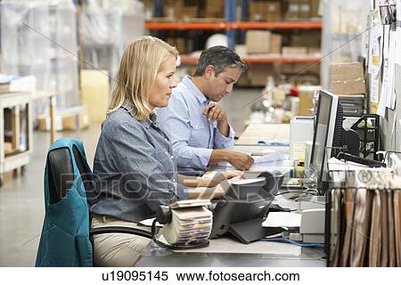 Business Colleagues Working At Desk In Warehouse View Large Photo Image Stock Photography - Business Colleagues Working At Desk In Warehouse. Fotosearch