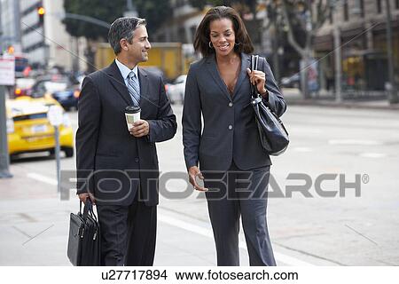 Picture - Businessman And Businesswoman In Street With Takeaway Coffee. Fotosearch