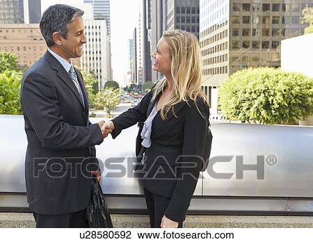 Businessman And Businesswoman Shaking Hands In Street View Large Photo Image Stock Image - Businessman And Businesswoman Shaking Hands In Street. Fotosearch