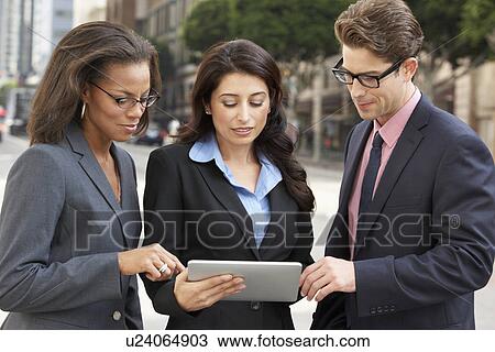 Businessman And Businesswomen Using Digital Tablet Outside View Large Photo Image Stock Image - Businessman And Businesswomen Using Digital Tablet Outside . Fotosearch