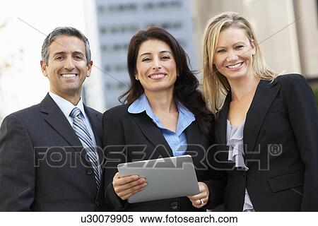 Businessman And Businesswomen Using Digital Tablet Outside View Large Photo Image Stock Photography - Businessman And Businesswomen Using Digital Tablet Outside . Fotosearch