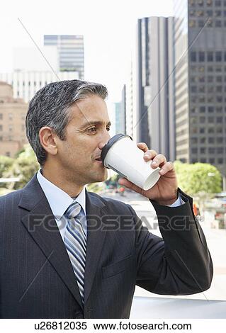 Stock Photography - Businessman Drinking Takeaway Coffee Outside Office. Fotosearch