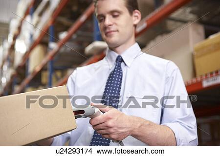 Businessman Scanning Package In Warehouse View Large Photo Image Picture - Businessman Scanning Package In Warehouse. Fotosearch